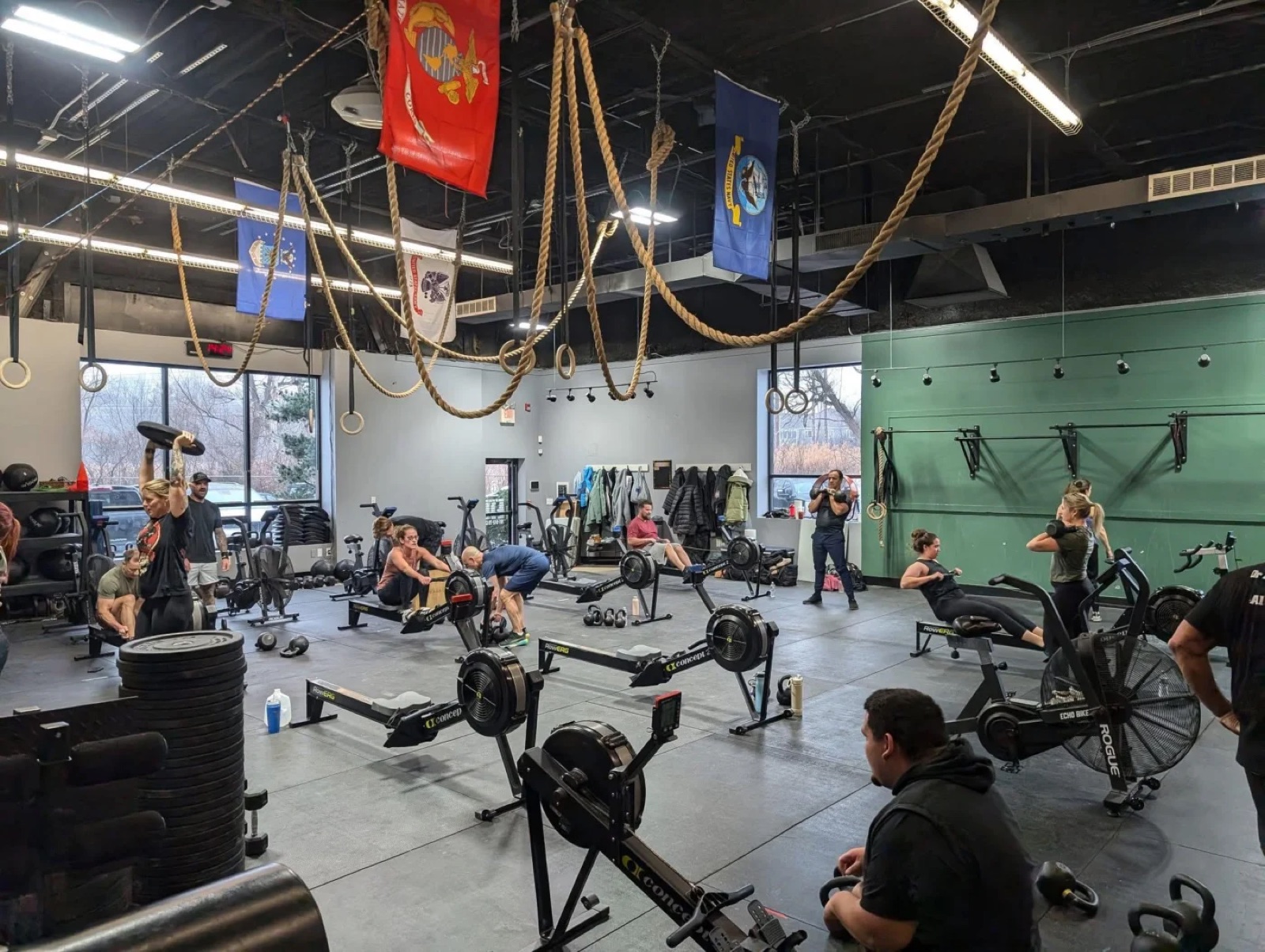 A busy CrossFit class training on rowers at East Coast CrossFit in Danvers