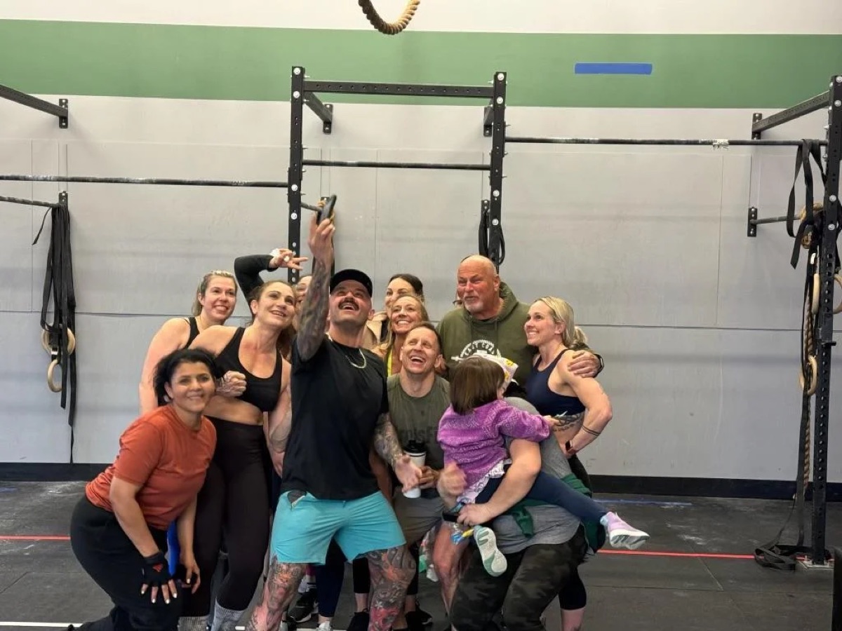 A class gathers for a group photo after training